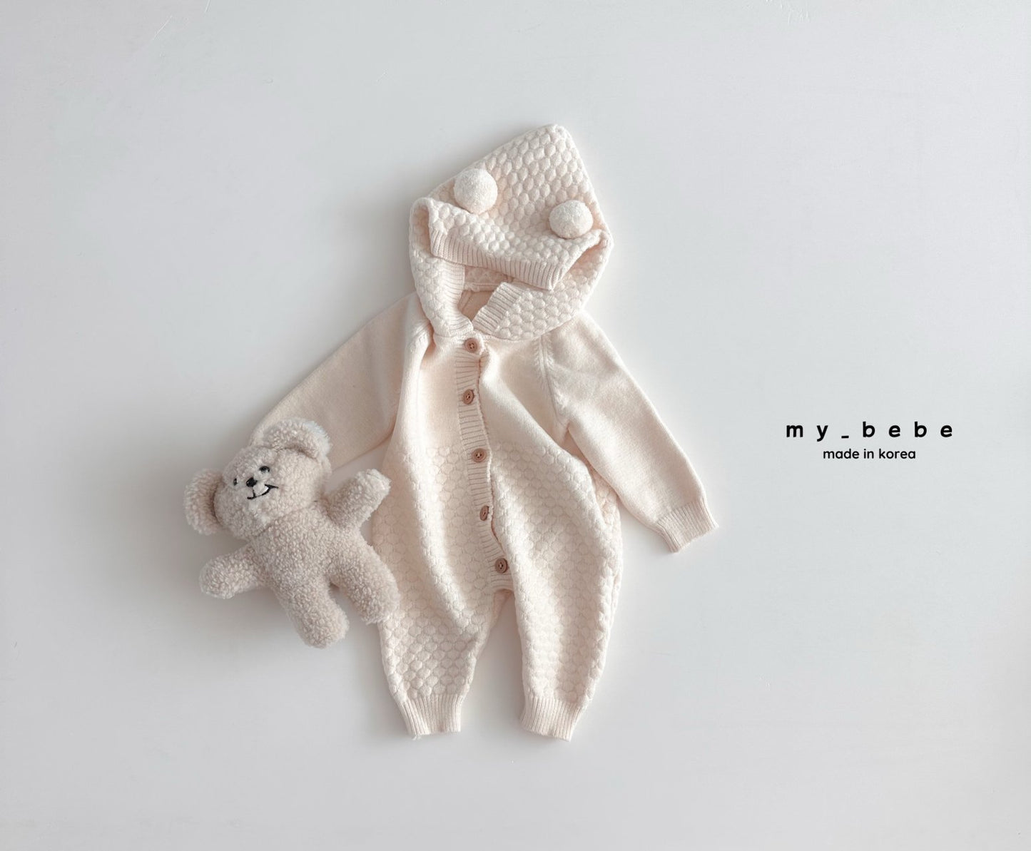 Pompom hooded knit onesie