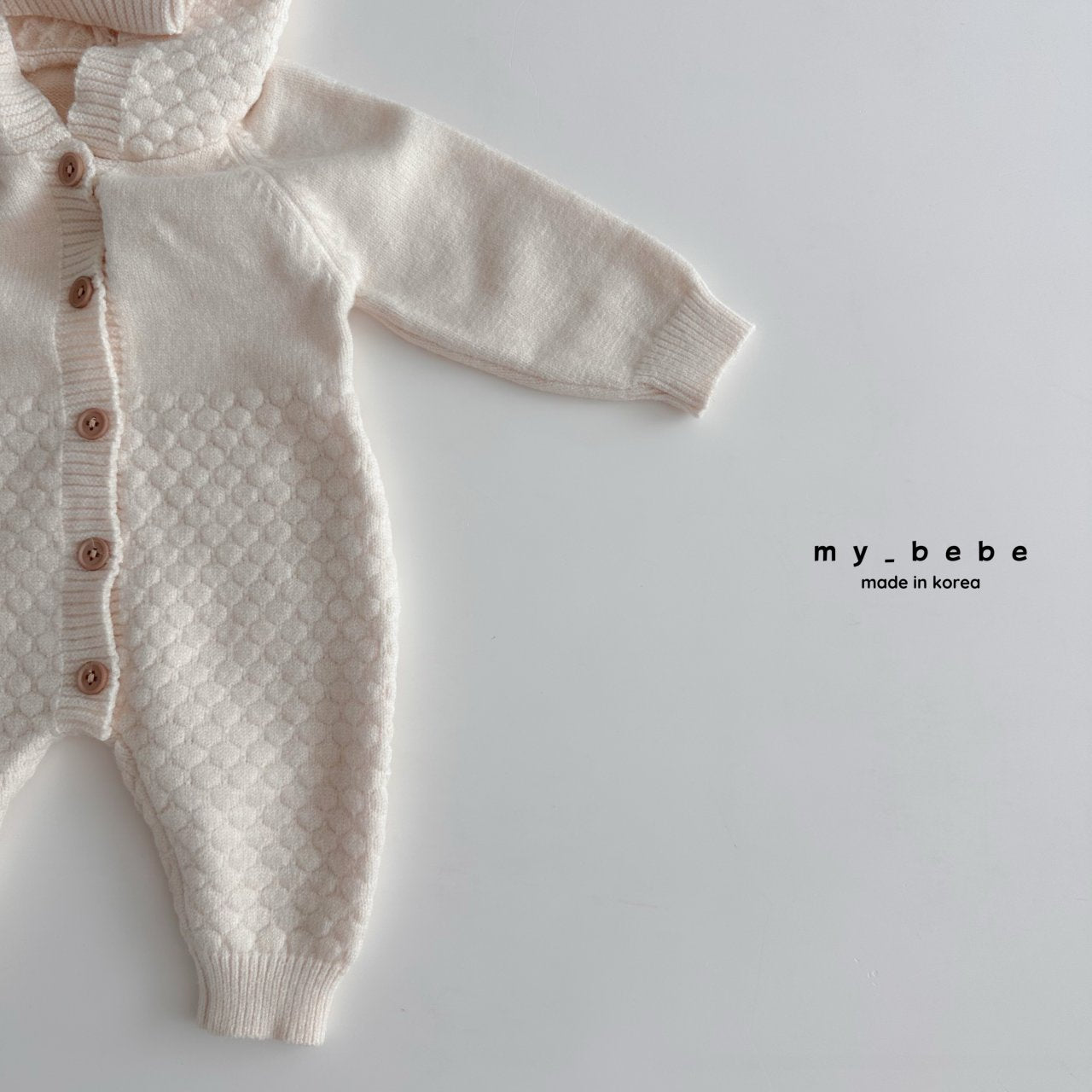 Pompom hooded knit onesie
